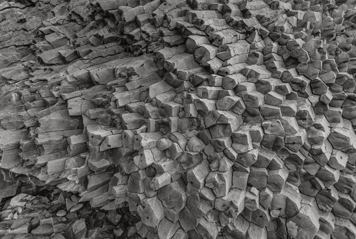 Light, near white, Hexagonal columnar basalt formations along Reynisfjara black sand beach in Vik í Myrdal Iceland.